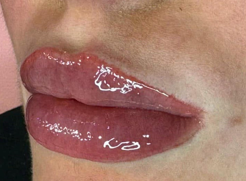 The same lips after lip blush permanent makeup, healed, soft rose and even.
